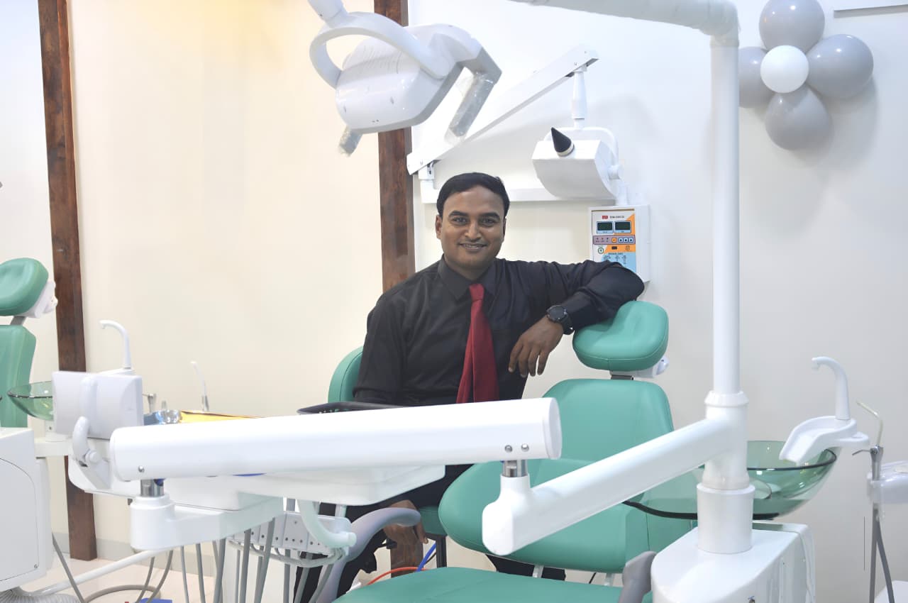 Dr. Nitin Sapat with a smiling patient at Shri Sai Dental Clinic